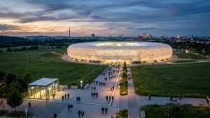 Ring-shaped arena glowing at dusk on the edge of Munich