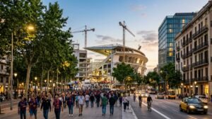 Fans walking along a tree-lined avenue toward Spotify Camp Nou in Les Corts, Barcelona