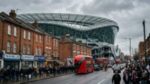 Modern football stadium above north London high street