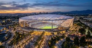 Futuristic Los Angeles stadium with translucent roof at dusk